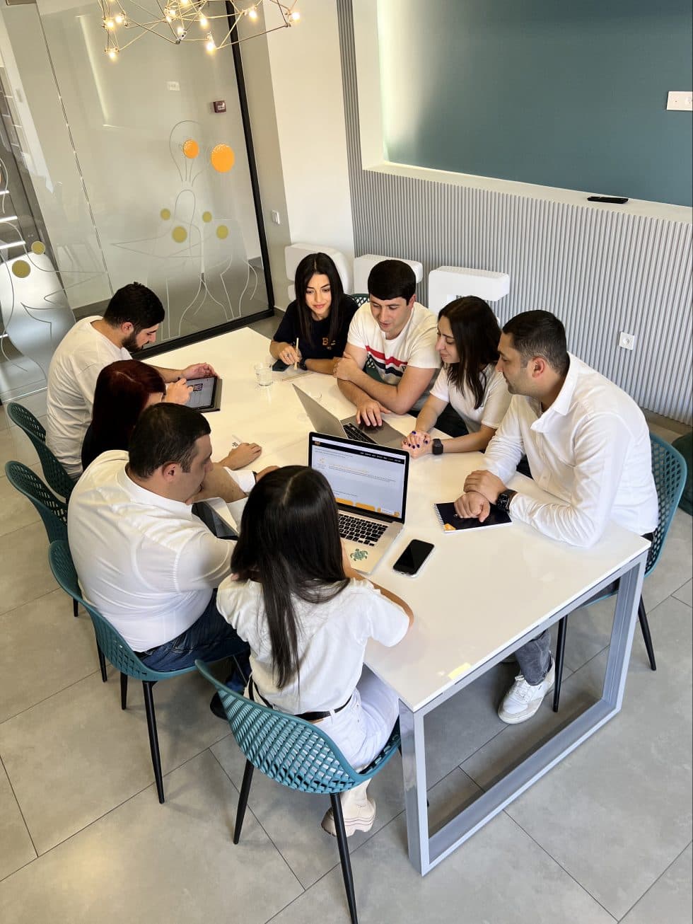 BeeWeb team collaborating around a table